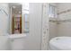 Bright bathroom with a sleek toilet, pedestal sink, bathtub, and patterned shower curtain at 2561 S Carey Way, Denver, CO 80222