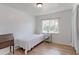 Clean bedroom featuring hardwood floors, side table, and a comfortable bed setup at 2561 S Carey Way, Denver, CO 80222