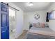 Cozy bedroom featuring a sliding door bathroom entrance and a comfortable bed with decorative pillows at 2561 S Carey Way, Denver, CO 80222
