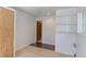 Neutral bedroom showcasing light wood floors, recessed lights, built-in shelves and multiple windows at 2561 S Carey Way, Denver, CO 80222
