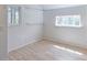 Bright, airy bedroom with wood-look floors, multiple windows and fresh white paint at 2561 S Carey Way, Denver, CO 80222