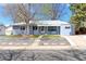 Charming light blue single story home with mature trees, tidy landscaping, and a welcoming walkway at 2561 S Carey Way, Denver, CO 80222