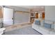 Open living room featuring tile flooring, coat rack, and flows to the kitchen and dining area at 2561 S Carey Way, Denver, CO 80222