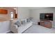 Cozy living room featuring a comfortable couch, plush pillows, and a modern entertainment center with TV at 2561 S Carey Way, Denver, CO 80222