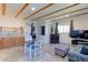 Open living area boasts wood beam ceilings, a dining table, and a cozy seating area at 2561 S Carey Way, Denver, CO 80222