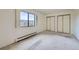 Simple bedroom features large window, neutral carpet, and sliding door closet at 13902 E Marina Dr # 412, Aurora, CO 80014