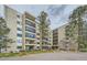 A condo building with multiple floors, balconies, and a lush green lawn at 13902 E Marina Dr # 412, Aurora, CO 80014