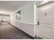 Hallway leading to the unit's front door, featuring carpet and neutral walls at 13902 E Marina Dr # 412, Aurora, CO 80014