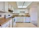 Cozy kitchen features white cabinets, a bright light fixture, and light countertops at 13902 E Marina Dr # 412, Aurora, CO 80014