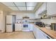 Well-lit kitchen with white cabinets and appliances, and ample counter space at 13902 E Marina Dr # 412, Aurora, CO 80014