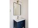 Modern bathroom showcasing vanity with blue cabinet, white sink, gold faucet, and rectangular mirror at 2720 N Saint Paul St, Denver, CO 80205