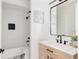 Modern bathroom featuring a wood vanity, black fixtures, and a tile shower with a built-in niche at 2720 N Saint Paul St, Denver, CO 80205