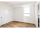 Light-filled bedroom featuring hardwood floors and a closet with sliding doors, creating a serene space at 2720 N Saint Paul St, Denver, CO 80205