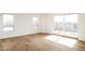 Bright bedroom with hardwood floors, light walls, large windows, and sliding glass doors to balcony at 2720 N Saint Paul St, Denver, CO 80205