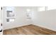 Bright bedroom features hardwood floors, white walls, and multiple windows for plenty of natural light at 2720 N Saint Paul St, Denver, CO 80205