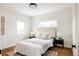 Comfortable bedroom with a decorative rug, a plush headboard, and great natural light from multiple windows at 2720 N Saint Paul St, Denver, CO 80205