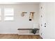 Welcoming entryway featuring a built-in bench, coat hooks, and wood flooring, offering a practical and stylish entrance at 2720 N Saint Paul St, Denver, CO 80205