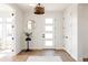 Elegant entryway with light hardwood floors, white door, modern lighting, and stylish decor at 2720 N Saint Paul St, Denver, CO 80205