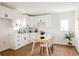 Bright kitchen with white cabinets and a cozy dining area perfect for casual meals and gatherings at 2720 N Saint Paul St, Denver, CO 80205