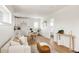 Open-concept living room with modern décor, seamlessly integrating a dining area and stylish, compact kitchen at 2720 N Saint Paul St, Denver, CO 80205