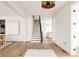 Spacious and bright living space featuring stairs, hardwood floors, and modern lighting at 2720 N Saint Paul St, Denver, CO 80205