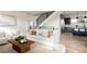 Bright living room with a modern staircase, hardwood floors, and stylish furniture, creating an inviting and open space at 2720 N Saint Paul St, Denver, CO 80205