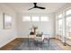 Bright home office with glass desk, chic chair, and large windows for ample natural light at 2720 N Saint Paul St, Denver, CO 80205