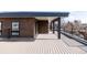 Modern rooftop deck with wood-like decking and black metal railings, perfect for outdoor entertaining at 2720 N Saint Paul St, Denver, CO 80205
