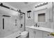Main bathroom with glass shower featuring modern fixtures and marble tiled walls at 11091 Clayton St, Northglenn, CO 80233