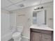 Bathroom featuring a toilet, tub and shower combo, white vanity and modern fixtures at 11091 Clayton St, Northglenn, CO 80233
