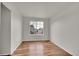 Bedroom with a wood floor and a view of the neighborhood at 11091 Clayton St, Northglenn, CO 80233