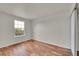 Bedroom with hardwood floors and a bright window overlooking a leafy landscape at 11091 Clayton St, Northglenn, CO 80233