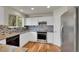 Modern kitchen with white cabinets, granite countertops, and stainless steel appliances at 11091 Clayton St, Northglenn, CO 80233