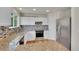 Modern kitchen with white cabinets, granite countertops, and stainless steel appliances at 11091 Clayton St, Northglenn, CO 80233