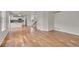 Open-concept living area with hardwood floors flowing into kitchen with breakfast bar at 11091 Clayton St, Northglenn, CO 80233