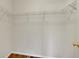 Walk-in closet with a wood floor and wire rack shelving system at 11091 Clayton St, Northglenn, CO 80233