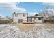 Backyard showing the patio, deck, updated home exterior, lawn, and fencing of the property at 11278 Clermont Dr, Thornton, CO 80233