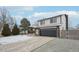 Exterior view of a two story home showing the driveway and two-car garage at 11278 Clermont Dr, Thornton, CO 80233