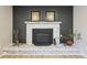 Close up view of the white-bricked fireplace with decorative mantle and decor at 11278 Clermont Dr, Thornton, CO 80233