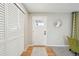 Bright foyer featuring hardwood floors, a coat closet, and modern decor at 11278 Clermont Dr, Thornton, CO 80233