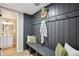 Inviting mud room featuring a bench, hooks, and a 'welcome' sign; half-bath adjacent at 11278 Clermont Dr, Thornton, CO 80233