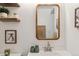 This bathroom has a small sink and floating shelves with decor at 18391 E Kepner Pl # 205, Aurora, CO 80017