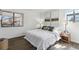 Bright bedroom featuring a large window, neutral walls, hardwood floors and comfortable furnishings at 18391 E Kepner Pl # 205, Aurora, CO 80017