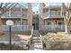 Multi-Gathering residential building with stone facade, balconies, and inviting stairway entrance at 18391 E Kepner Pl # 205, Aurora, CO 80017