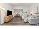 Bright living room with modern flooring, a comfortable couch, and ample natural light at 18391 E Kepner Pl # 205, Aurora, CO 80017