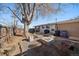 Backyard with firepit, patio furniture, and mature tree at 2753 S Meade St, Denver, CO 80236