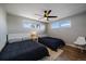 Guest bedroom with twin beds, hardwood floors, and ceiling fan at 2753 S Meade St, Denver, CO 80236