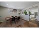 Mid century modern dining room with a view into the kitchen at 2753 S Meade St, Denver, CO 80236