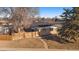 Back exterior of ranch house, showing wooden fence and landscaping at 2753 S Meade St, Denver, CO 80236