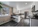 Modern kitchen with white cabinets and dark countertops at 2753 S Meade St, Denver, CO 80236